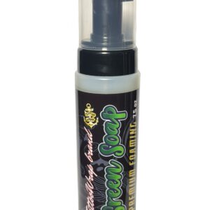 Close-up of a black spray bottle with a clear plastic cap, likely a tattoo aftercare product.