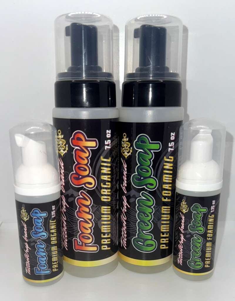 Four foam soap bottles: two tall spray bottles and two small pump bottles, labeled Premium Organic Foam Soap with colorful red and green text on black labels.